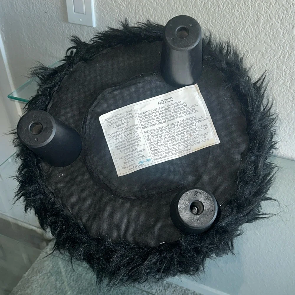 black faux fur ottoman/stool with 3 wooden legs